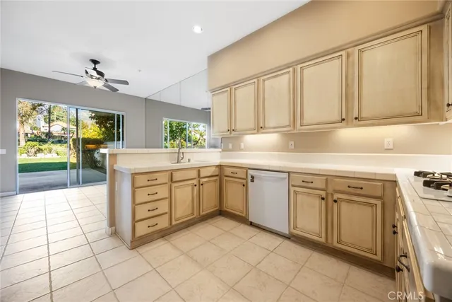 a kitchen with a stove a sink and a refrigerator