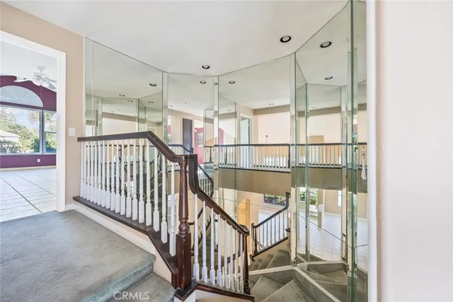a view of staircase with white walls and windows