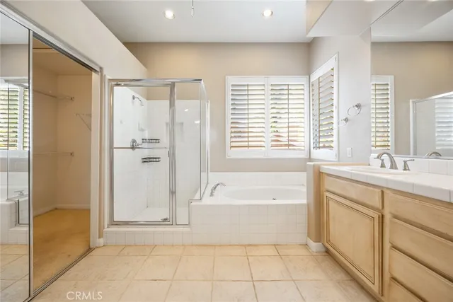 a spacious bathroom with a tub shower and sink