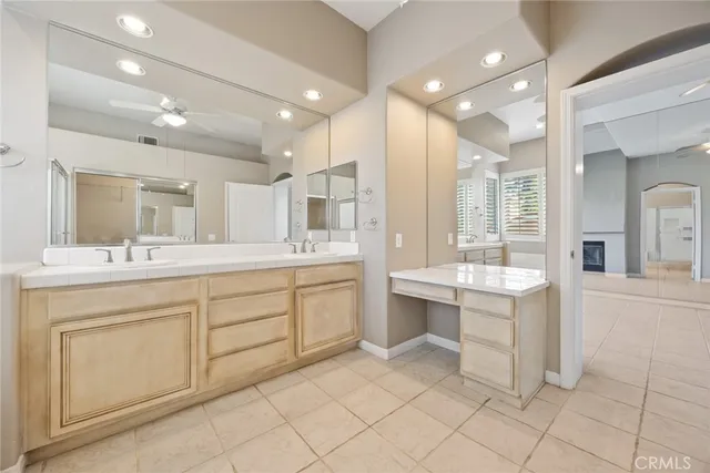 a bathroom with a sink vanity and mirror