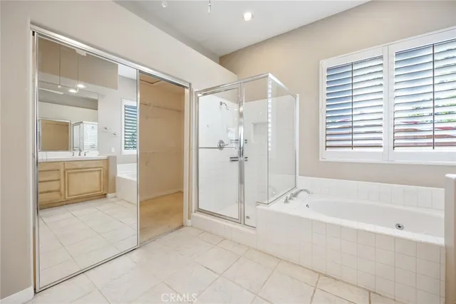a spacious bathroom with a bathtub shower and sink