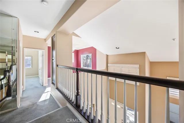 an empty room with windows and ceiling fan
