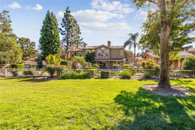 a front view of a house with a yard and potted plants