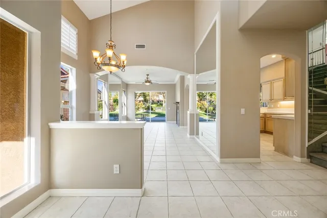 a view of a hallway with wooden floor and a living room
