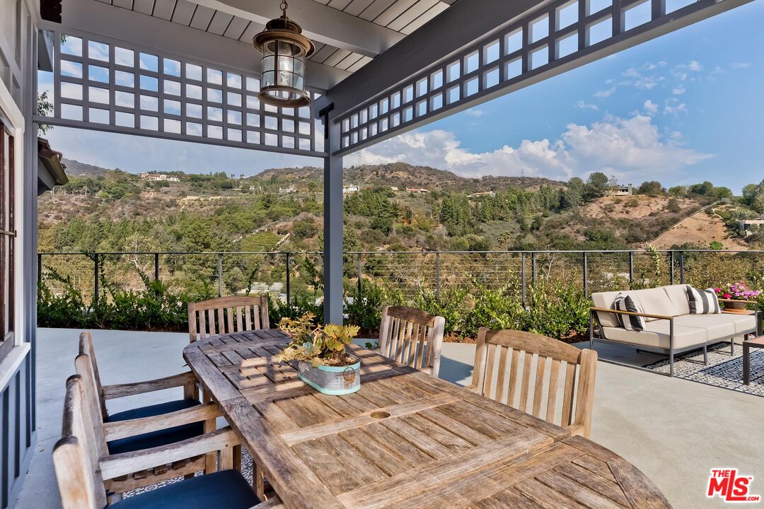 13240 Chalon Road Los Angeles, CA 90049 - Photo 1 of 46 a view of a patio with a table chairs and a table