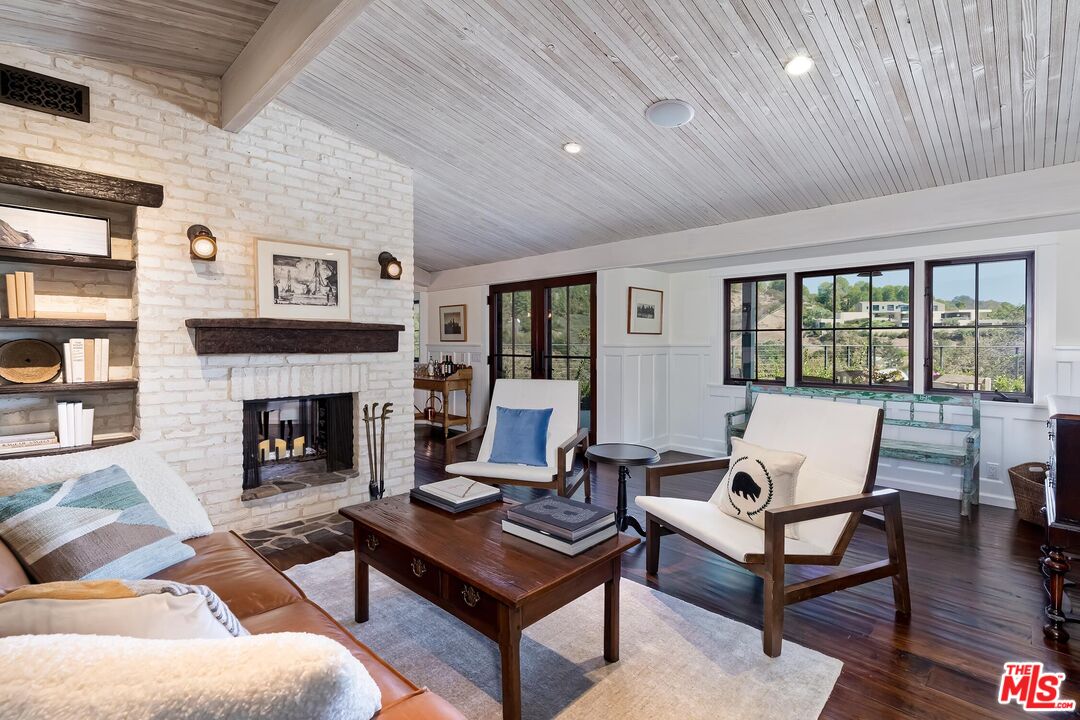 13240 Chalon Road Los Angeles, CA 90049 - Photo 11 of 46 a living room with furniture and a fireplace