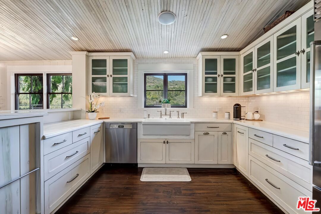 13240 Chalon Road Los Angeles, CA 90049 - Photo 14 of 46 a open kitchen with granite countertop a sink window and cabinets