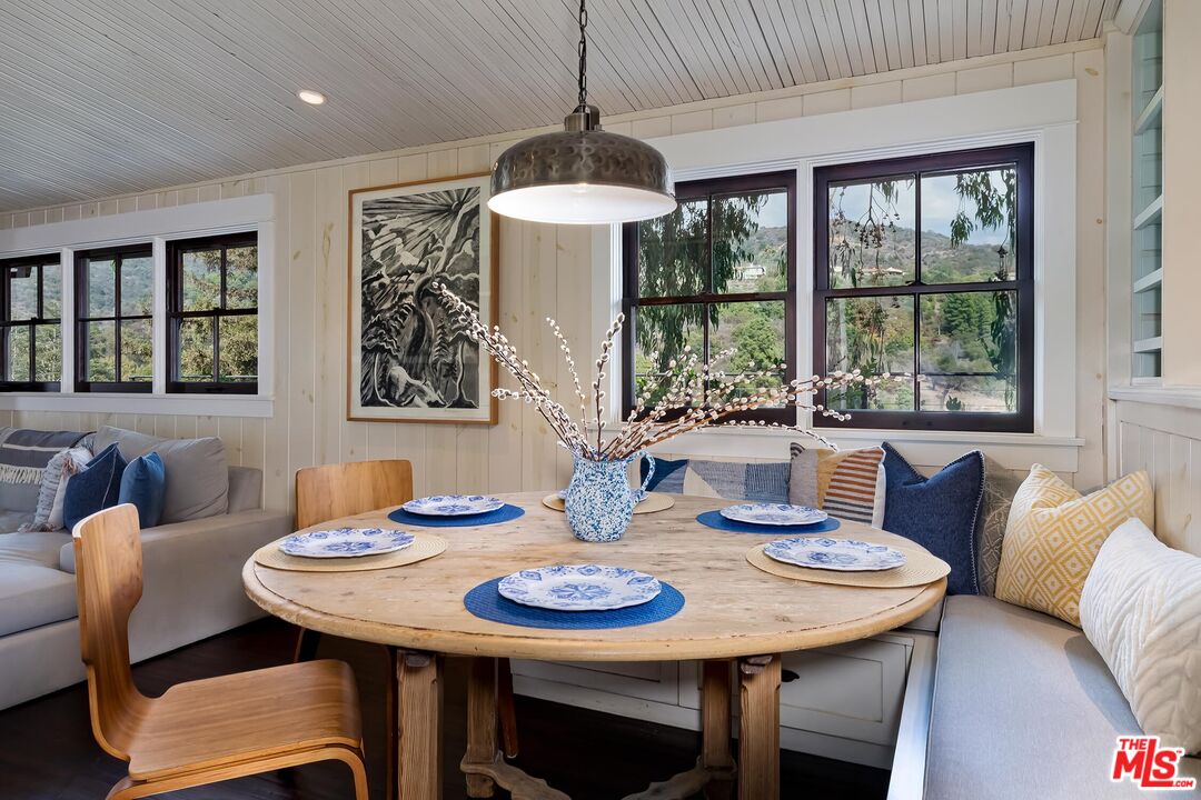 13240 Chalon Road Los Angeles, CA 90049 - Photo 17 of 46 a view of a dining room with furniture window and outside view