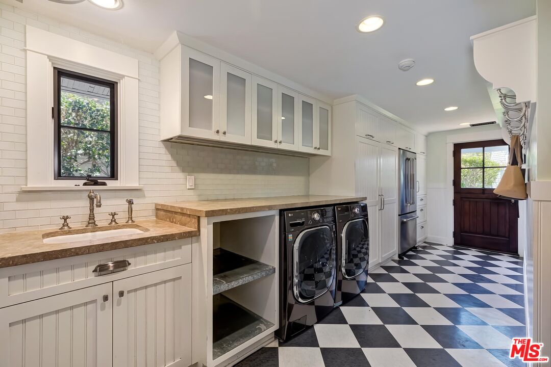 13240 Chalon Road Los Angeles, CA 90049 - Photo 19 of 46 a kitchen with granite countertop a sink a stove and a window