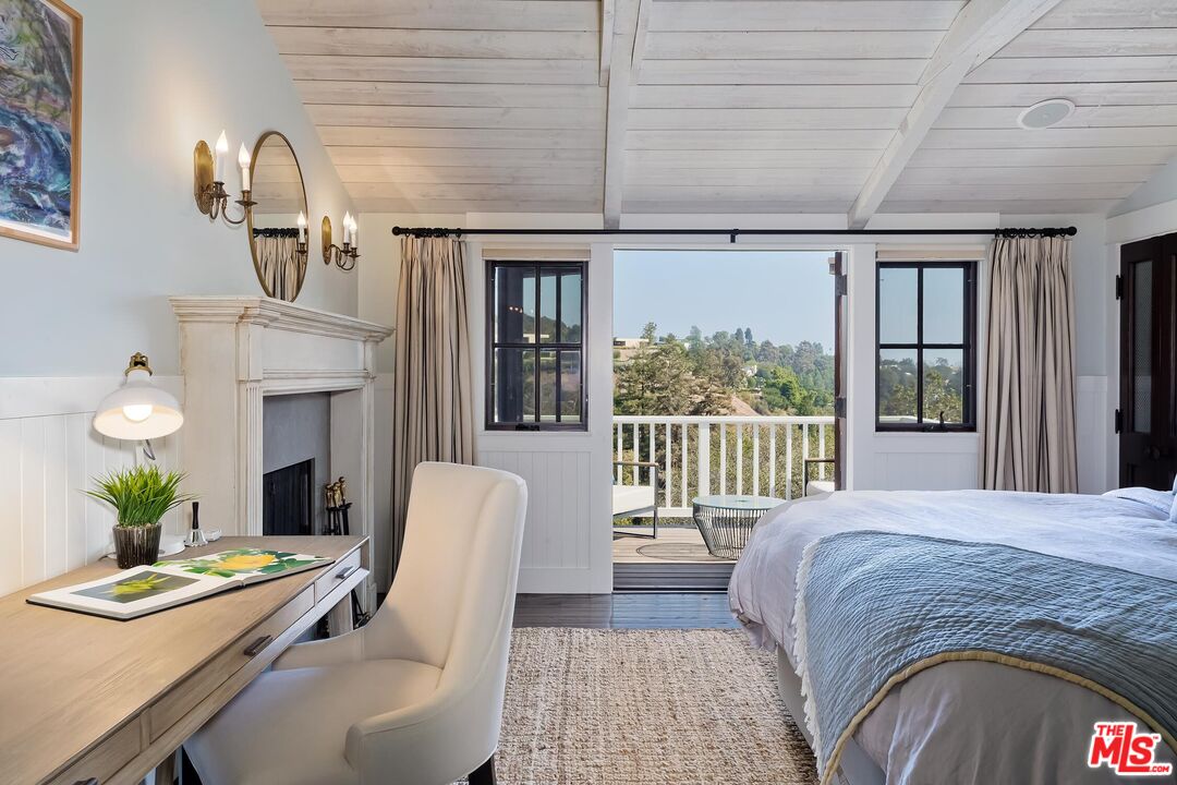 13240 Chalon Road Los Angeles, CA 90049 - Photo 21 of 46 a bedroom with a bed table flowerpot and window