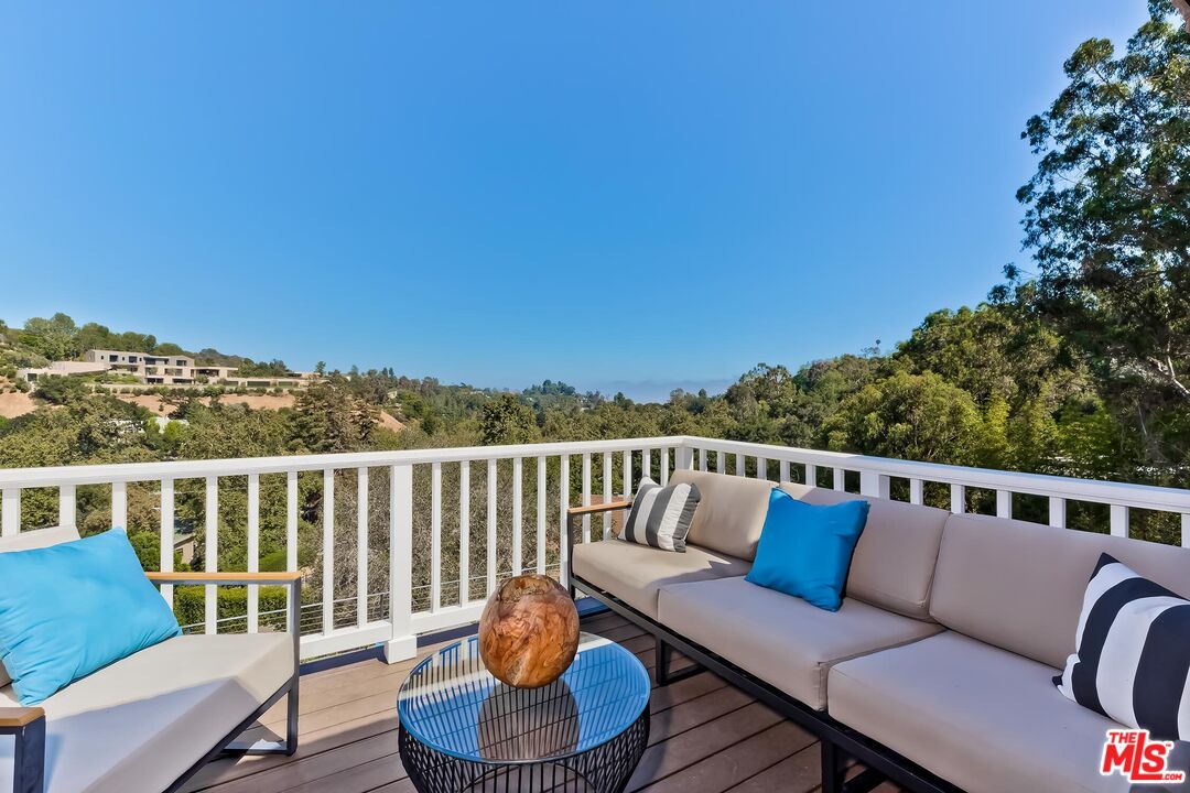 13240 Chalon Road Los Angeles, CA 90049 - Photo 23 of 46 a balcony with wooden floor and city view