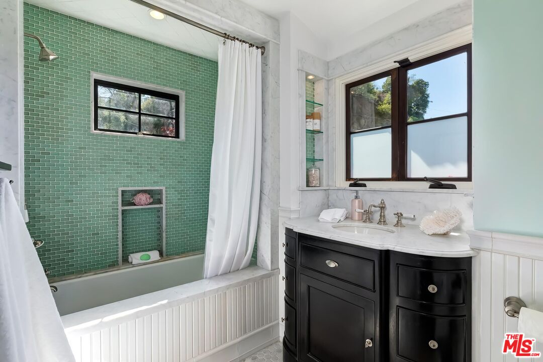 13240 Chalon Road Los Angeles, CA 90049 - Photo 27 of 46 a bathroom with a sink and a mirror