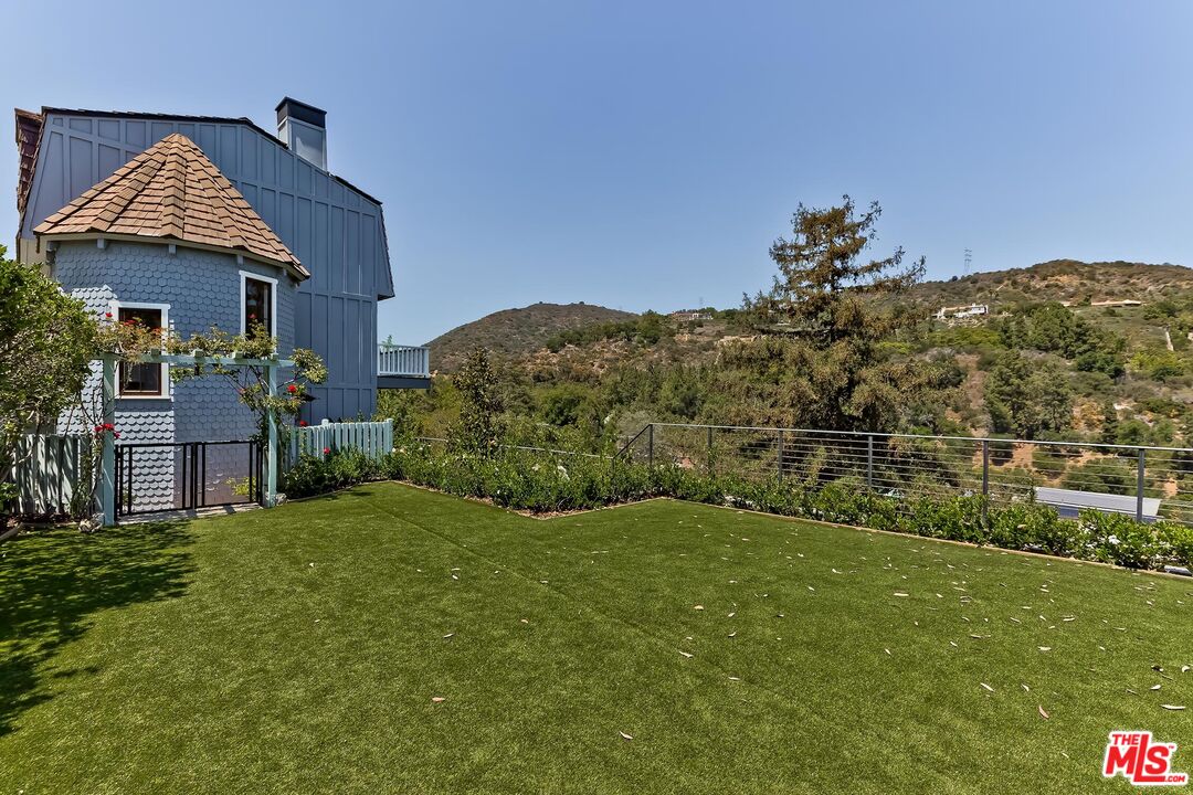 13240 Chalon Road Los Angeles, CA 90049 - Photo 30 of 46 a view of a house with a yard