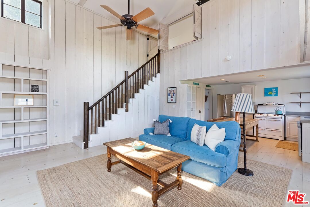 13240 Chalon Road Los Angeles, CA 90049 - Photo 35 of 46 a living room with furniture a ceiling fan and a rug