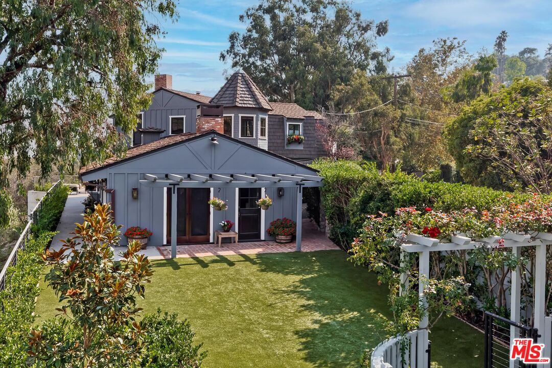 13240 Chalon Road Los Angeles, CA 90049 - Photo 41 of 46 a front view of a house with garden
