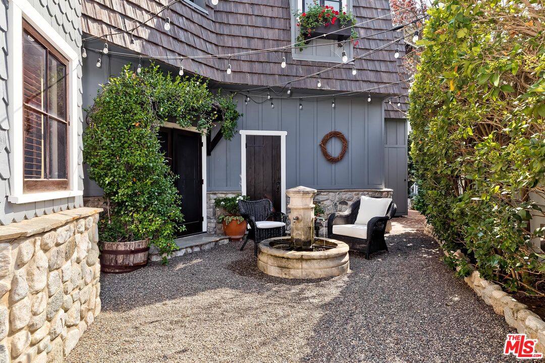 13240 Chalon Road Los Angeles, CA 90049 - Photo 43 of 46 a view of a patio with table and chairs and potted plants
