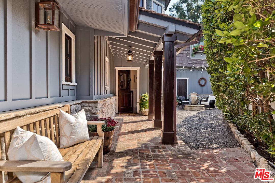 13240 Chalon Road Los Angeles, CA 90049 - Photo 44 of 46 a view of a chair and tables in the patio