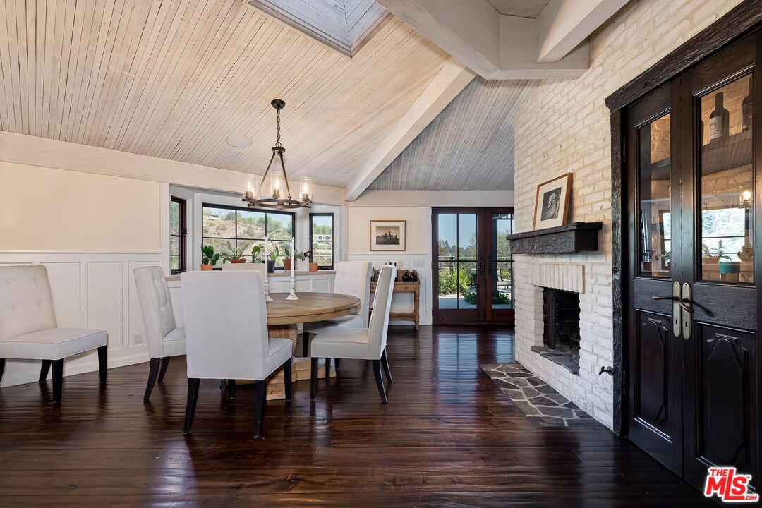 13240 Chalon Road Los Angeles, CA 90049 - Photo 6 of 46 a view of a dining room with furniture window and wooden floor