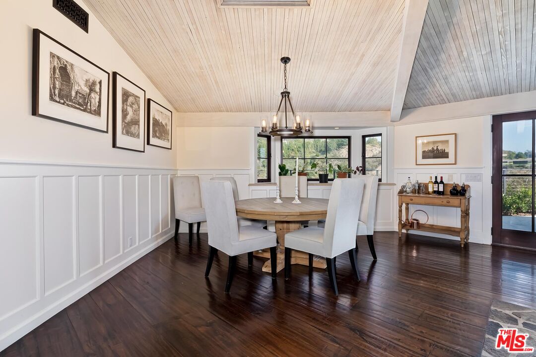 13240 Chalon Road Los Angeles, CA 90049 - Photo 7 of 46 a view of a dining room with furniture window and wooden floor