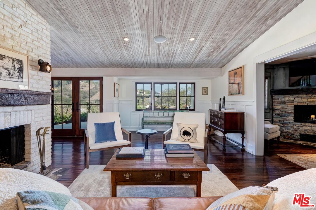 13240 Chalon Road Los Angeles, CA 90049 - Photo 9 of 46 a living room with fireplace furniture and a wooden floor
