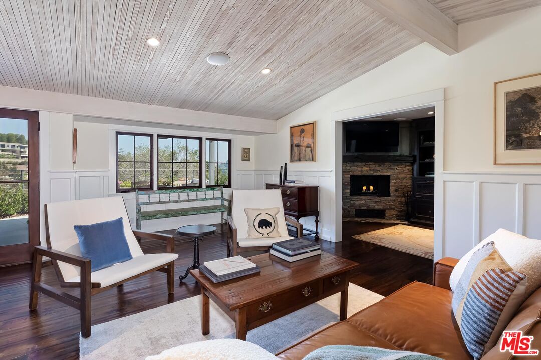 13240 Chalon Road Los Angeles, CA 90049 - Photo 10 of 46 a living room with furniture and a fireplace