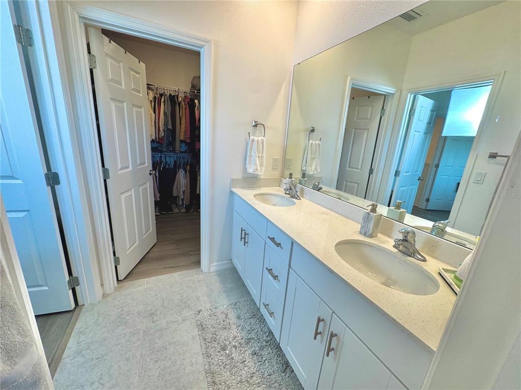 1301 Wycliffe Way St. Cloud, FL 34771 - Photo 15 of 50 a spacious bathroom with a double vanity sink and a mirror