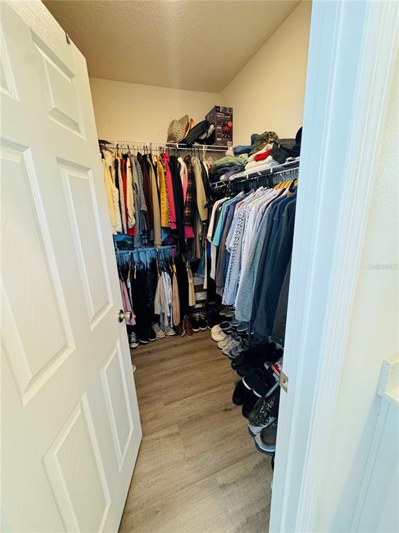 1301 Wycliffe Way St. Cloud, FL 34771 - Photo 16 of 50 a view of walk in closet with clothes