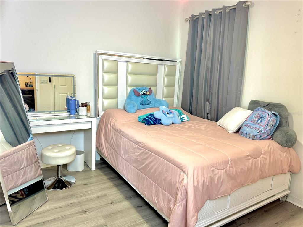1301 Wycliffe Way St. Cloud, FL 34771 - Photo 21 of 50 a bedroom with a bed and a chair