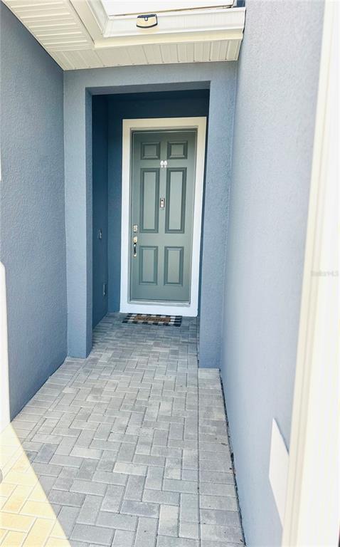 1301 Wycliffe Way St. Cloud, FL 34771 - Photo 3 of 50 a view of a hallway with wooden floor and a window