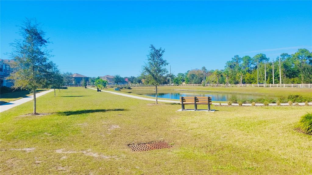 1301 Wycliffe Way St. Cloud, FL 34771 - Photo 32 of 50 a view of a swimming pool with an outdoor space and seating area