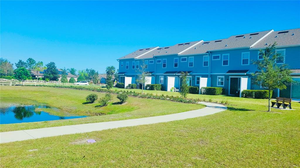 1301 Wycliffe Way St. Cloud, FL 34771 - Photo 36 of 50 a view of a house with a big yard and palm trees