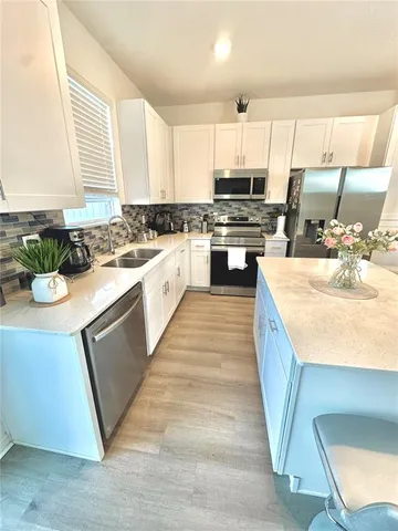 a view of a hallway with a white walls and wooden floor