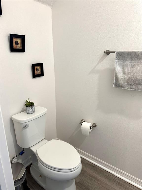 1301 Wycliffe Way St. Cloud, FL 34771 - Photo 9 of 50 a white toilet sitting next to a bathroom sink
