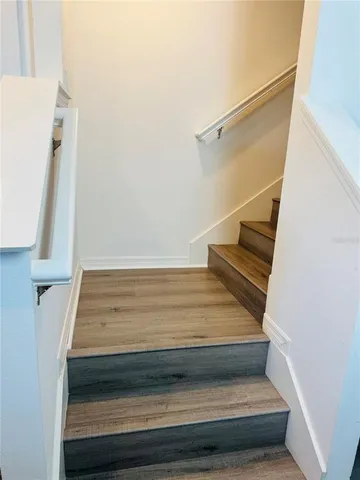 a room with a walk in closet and wooden floor