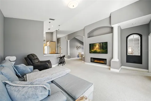 a bedroom with a bed flat screen tv and a large window with the outer view