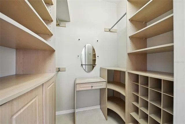 a view of walk in closet with empty racks