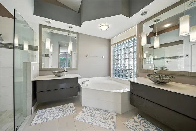 a bathroom with a bathtub toilet sink and mirror
