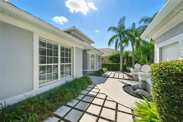 a view of a house with backyard and sitting area