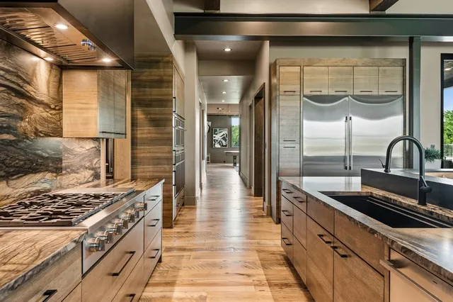 a kitchen with stainless steel appliances a stove and a refrigerator
