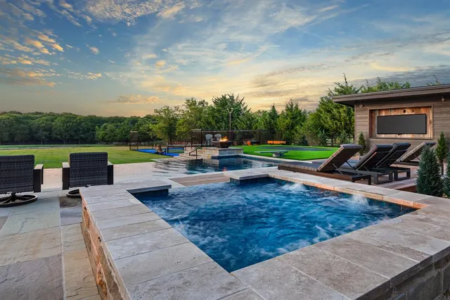 a view of a backyard with sitting area
