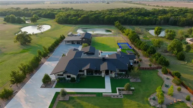 an aerial view of a house with outdoor space swimming pool