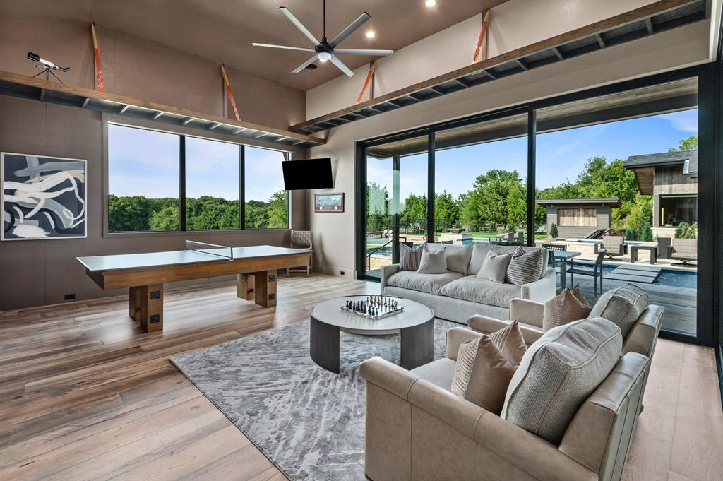 988 English Road Rockwall, TX 75032 - Photo 29 of 40 a living room with furniture a ceiling fan and a floor to ceiling window