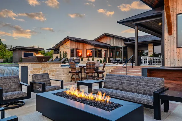 a outdoor living space with furniture and a fireplace