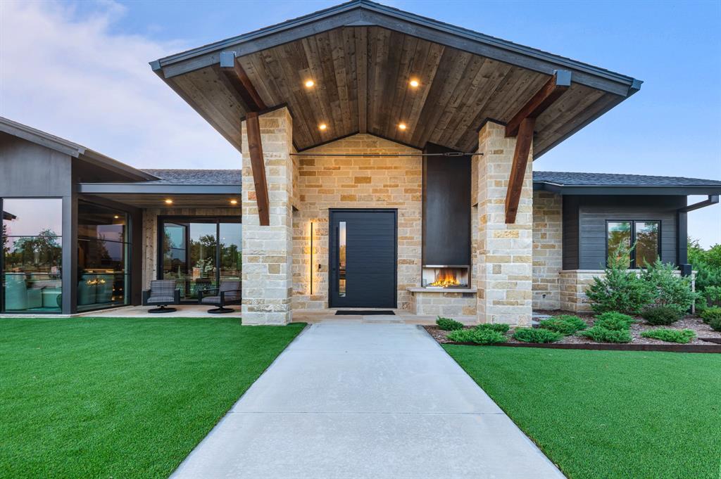 988 English Road Rockwall, TX 75032 - Photo 3 of 40 a front view of a house with a yard and porch