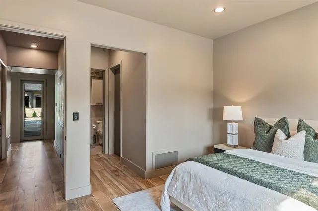 a bedroom with a bed and wooden floor