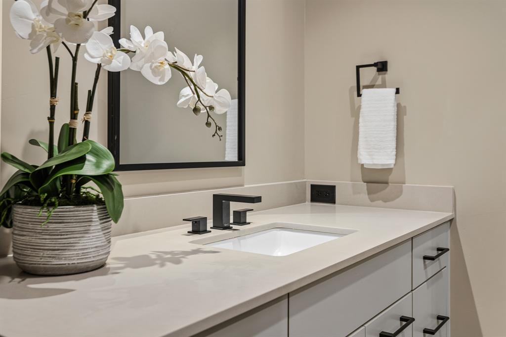988 English Road Rockwall, TX 75032 - Photo 34 of 40 a bathroom with a sink and a mirror