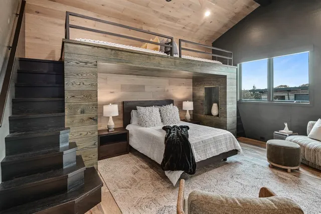 a bed room with a bed and a chair