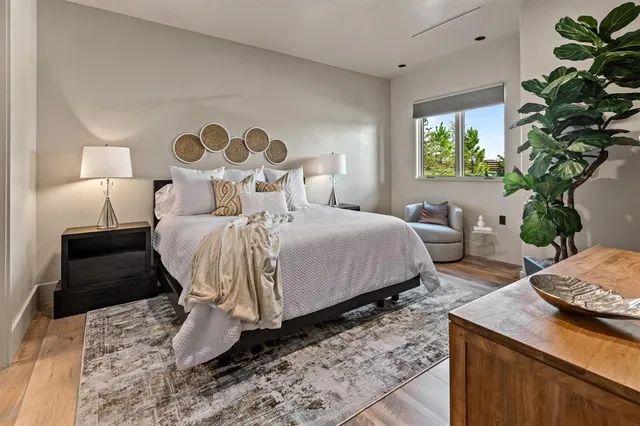 a bedroom with a bed and a potted plant