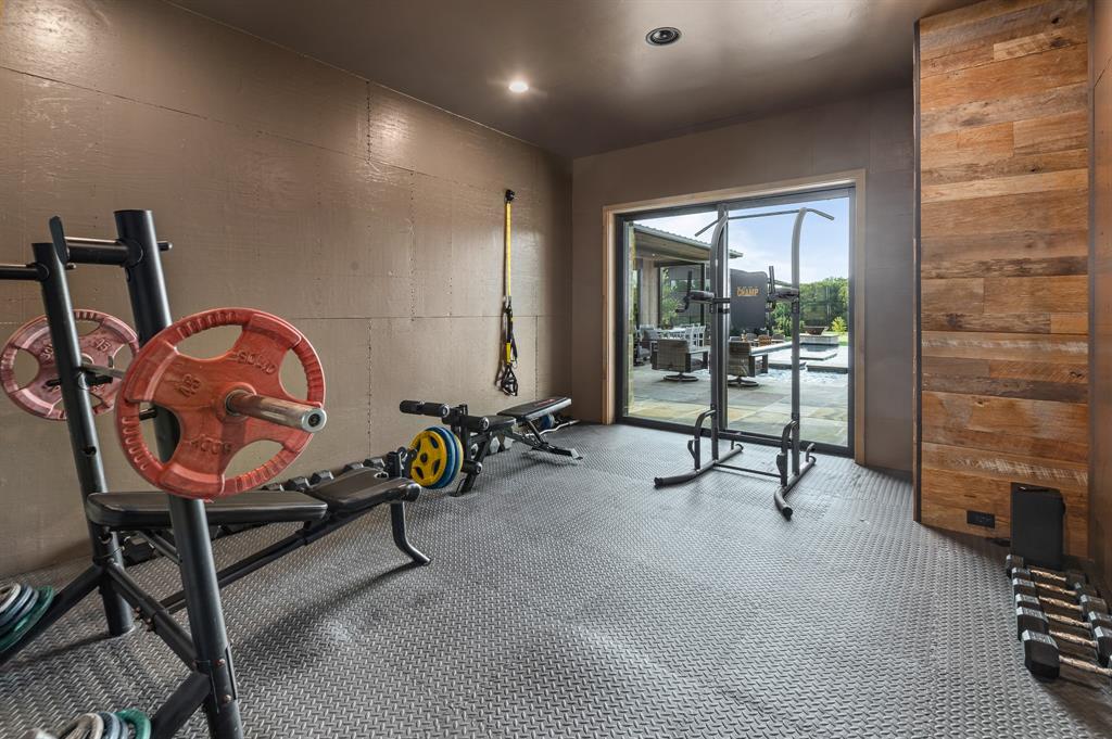 988 English Road Rockwall, TX 75032 - Photo 37 of 40 a living room with furniture a flat screen tv and a fireplace