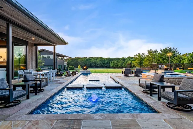 swimming pool view with a seating space